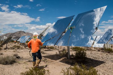Workers clean heliostats at the Ivanpah Solar Project, California, USA