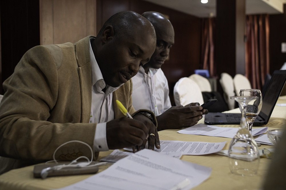 Members of the Africa Mini-Grids Community of Practice from Cote d’Ivoire prepare a session on their mini-grids country context at a workshop in Abuja, Nigeria. Photo: Geraint Hill, 2018
