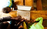 African kids and teacher using laptop