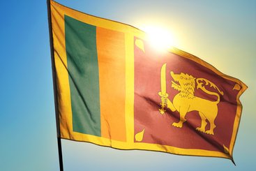 Sri Lanka flag waving on the wind in front of sun