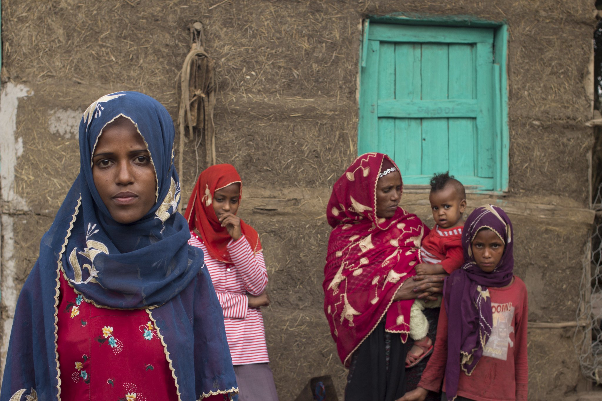 A girl and the family she supported with her earnings in Saudi Arabia following an early marriage. The family now live in Hara, Amhara Region, Ethiopia