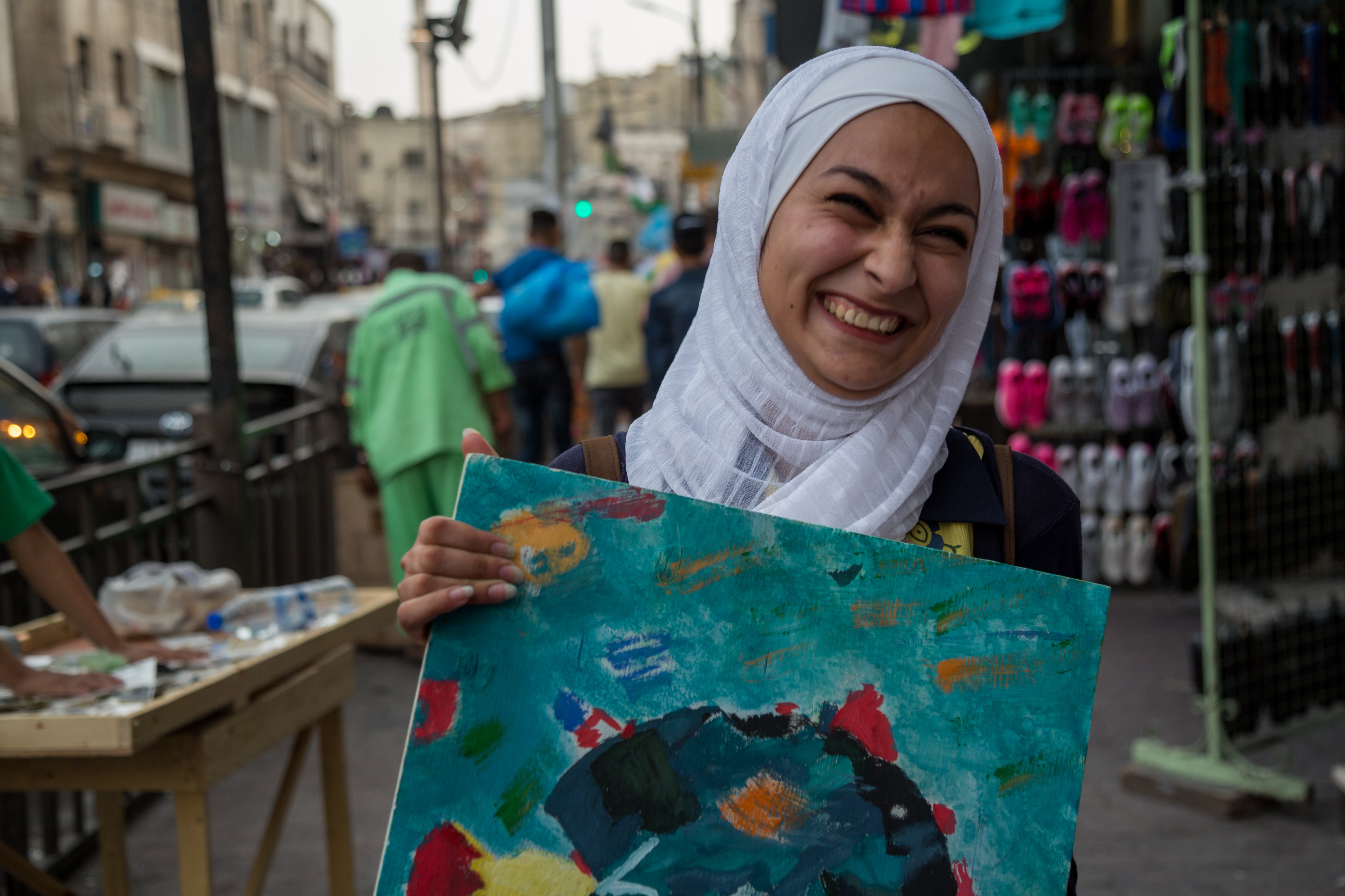 17-year-old Jordanian girl with one of her paintings