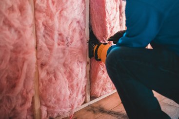 Installation of fabric insulation in home.