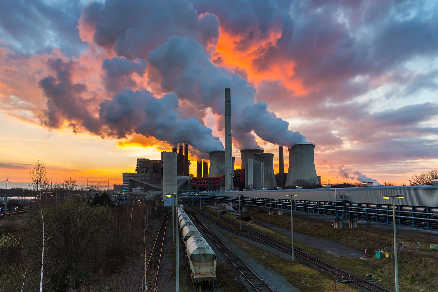 Lignite Power Plant at sunset with cloudy sky in Neurath, Germany.