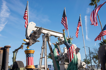 Oil field workers celebrate Donald Trump's victory and partnership with the oil industry by decorating oil pumps in with American flags and statues.