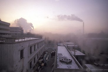 View of rooftops and smokestacks. China