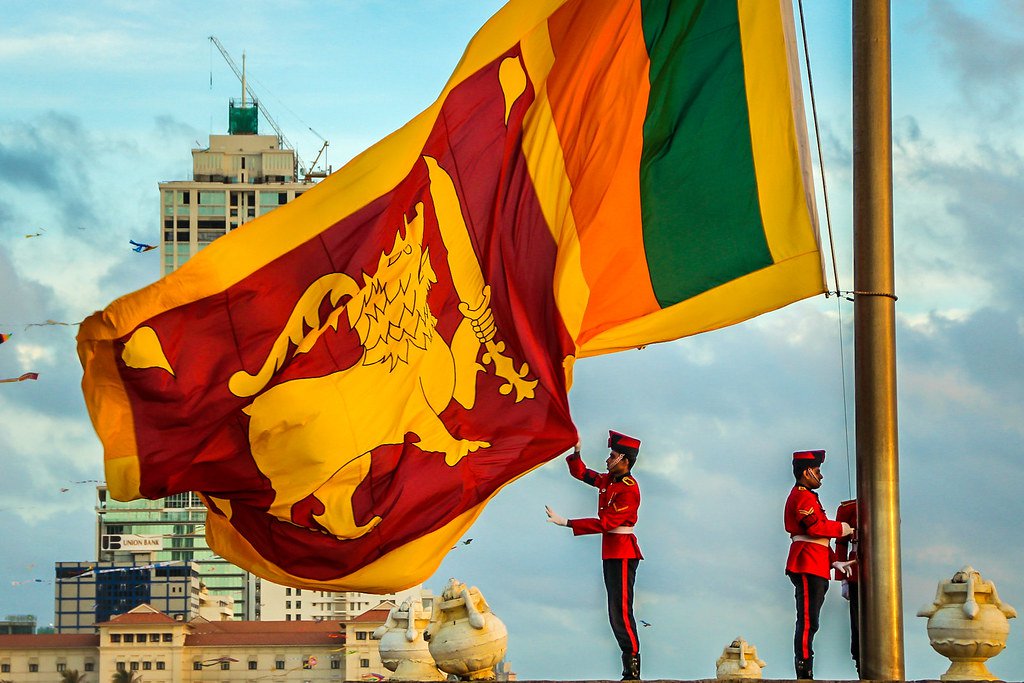 Sri Lankan flag being lowered down at the end of the day in Colombo